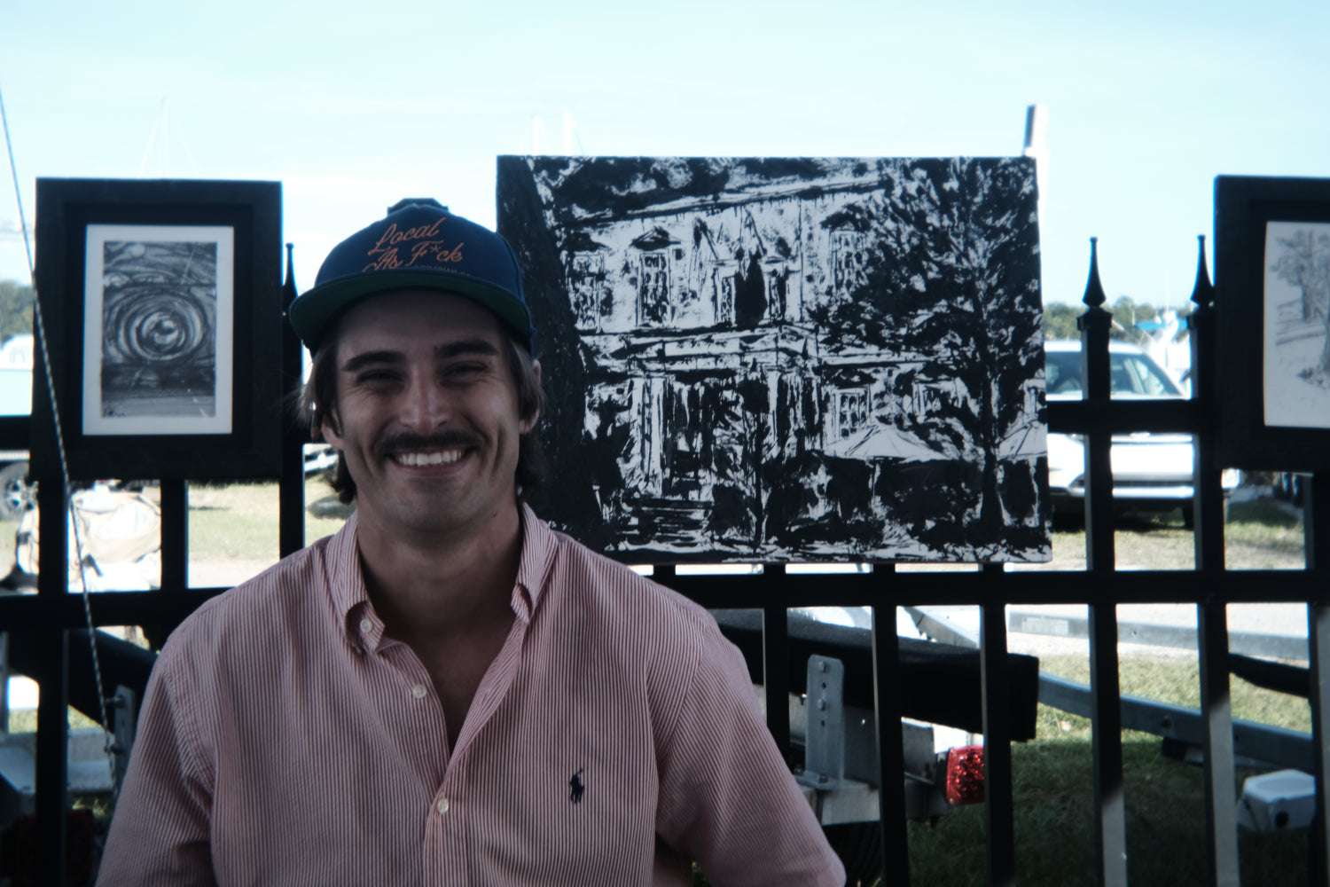 Brooks Davis II with his graphite work at the Isle of Hope Art and Music Festival